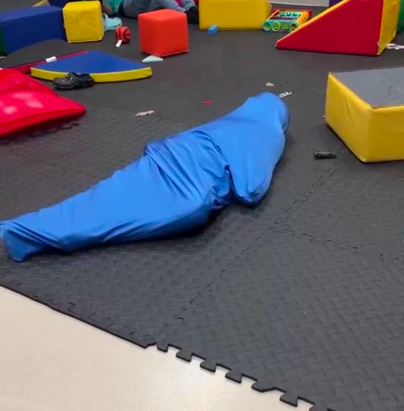 Child wearing a sensory compression sock for calming proprioceptive input